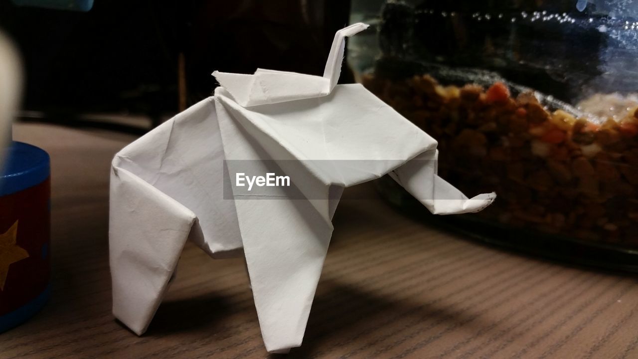 White paper crane on table