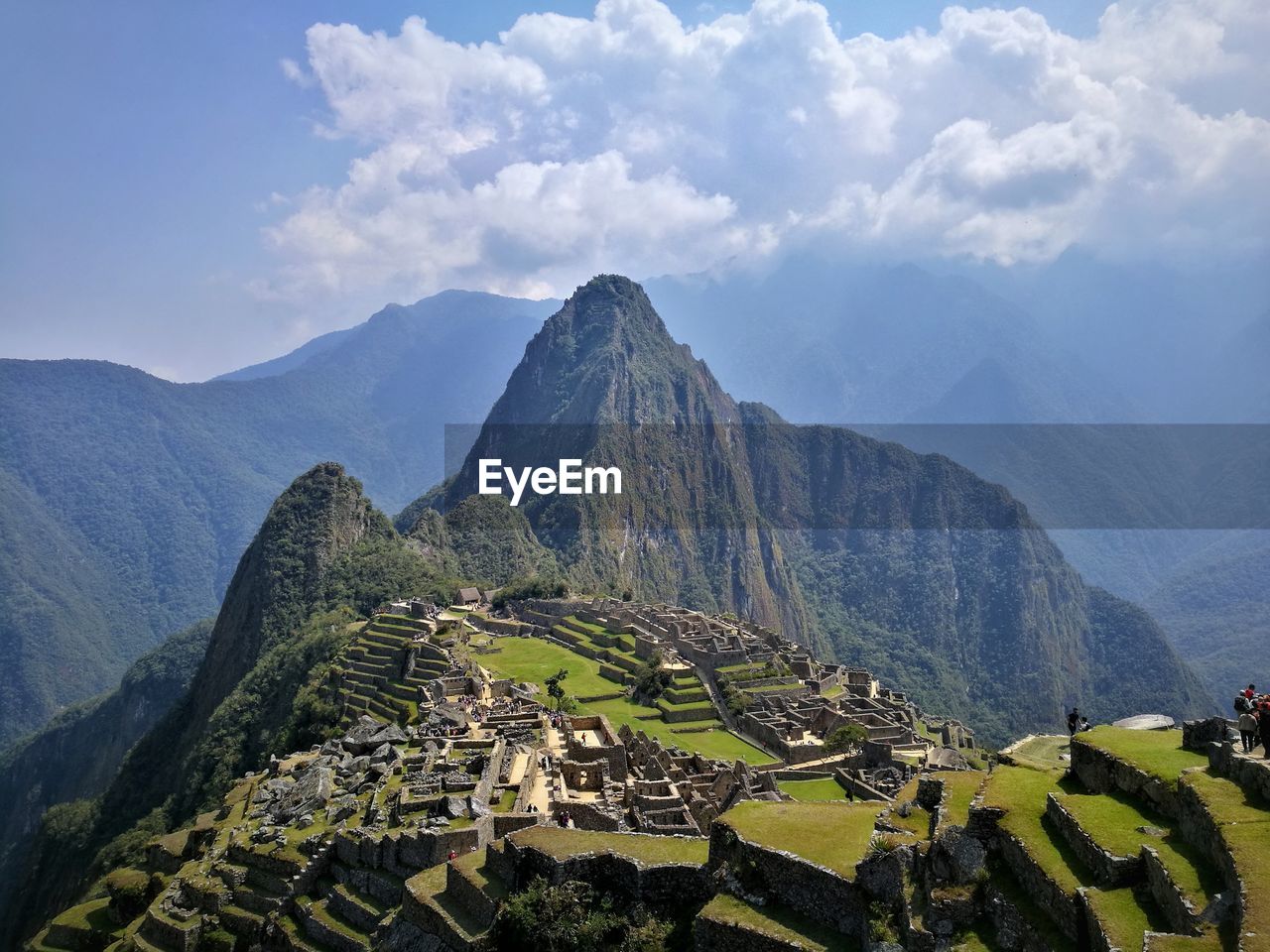 Panoramic view of old ruins on mountain against cloudy sky