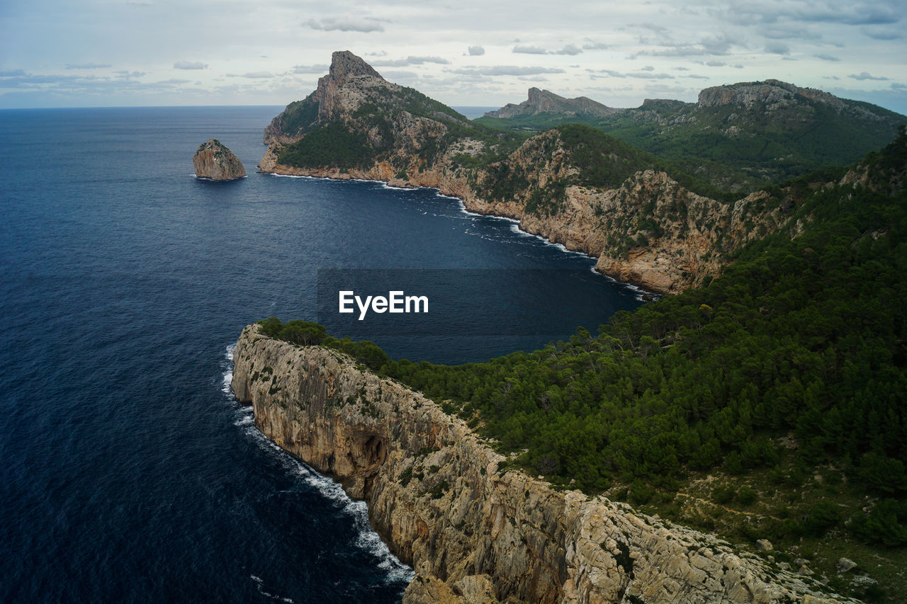 Scenic view of sea and mountains against sky