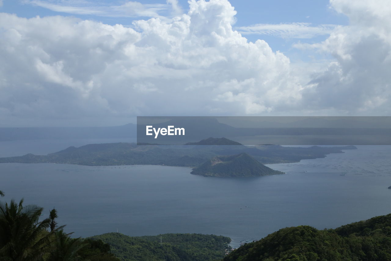 Scenic view of sea and mountains against sky