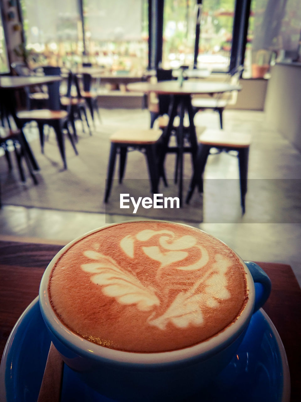 CLOSE-UP OF COFFEE CUP ON TABLE