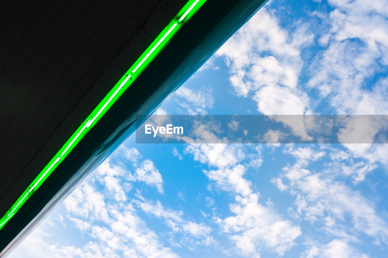 Low angle view of illuminated roof against cloudy sky