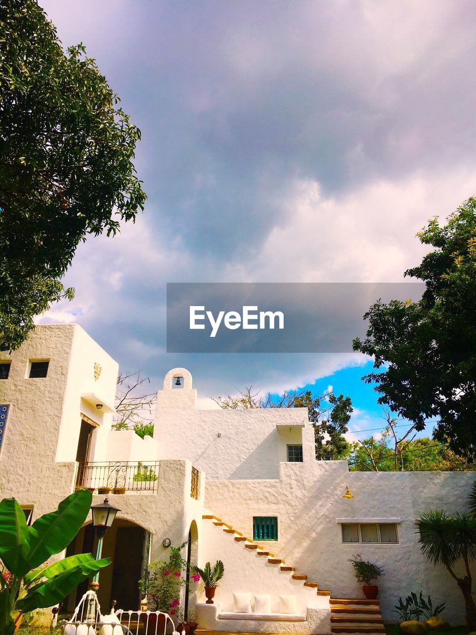 Houses against cloudy sky