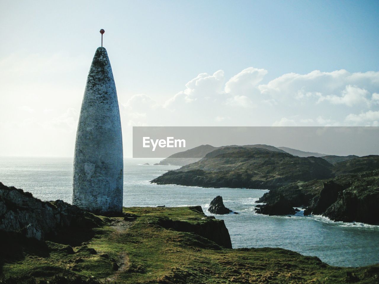 Baltimore beacon by sea against sky