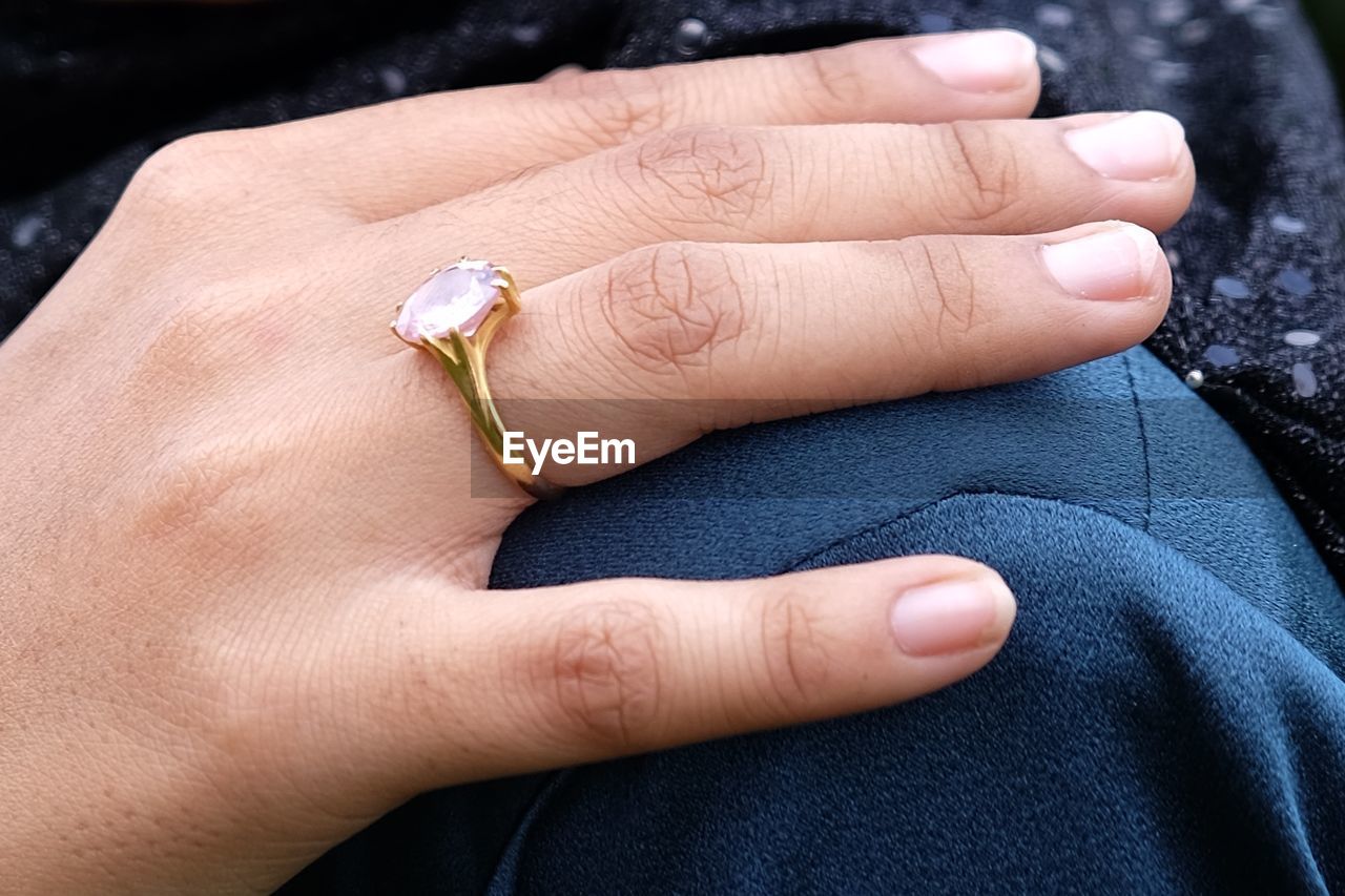 Close-up of hand wearing diamond ring