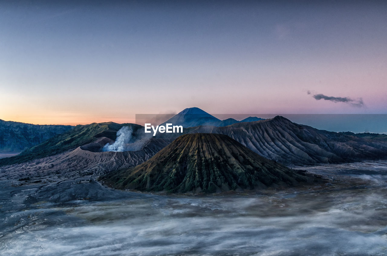 View of volcanic landscape against sky during sunset