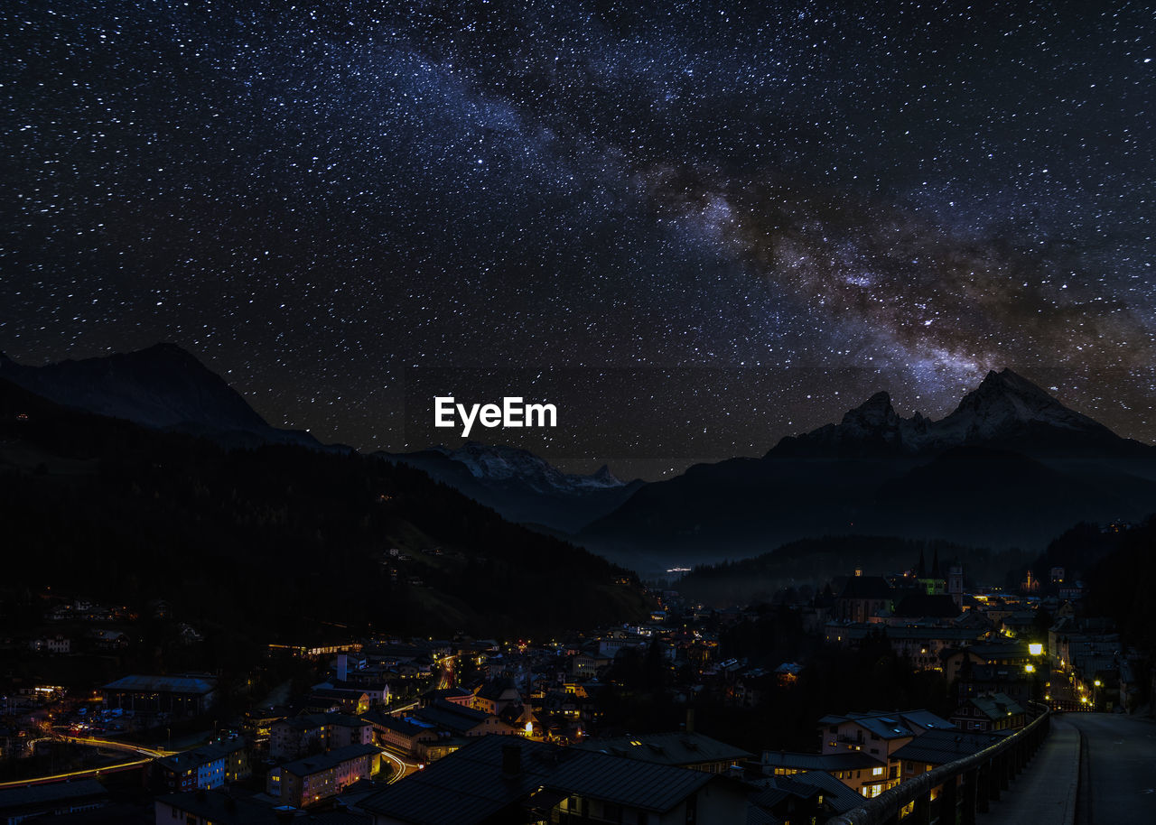 Illuminated mountains against sky at night