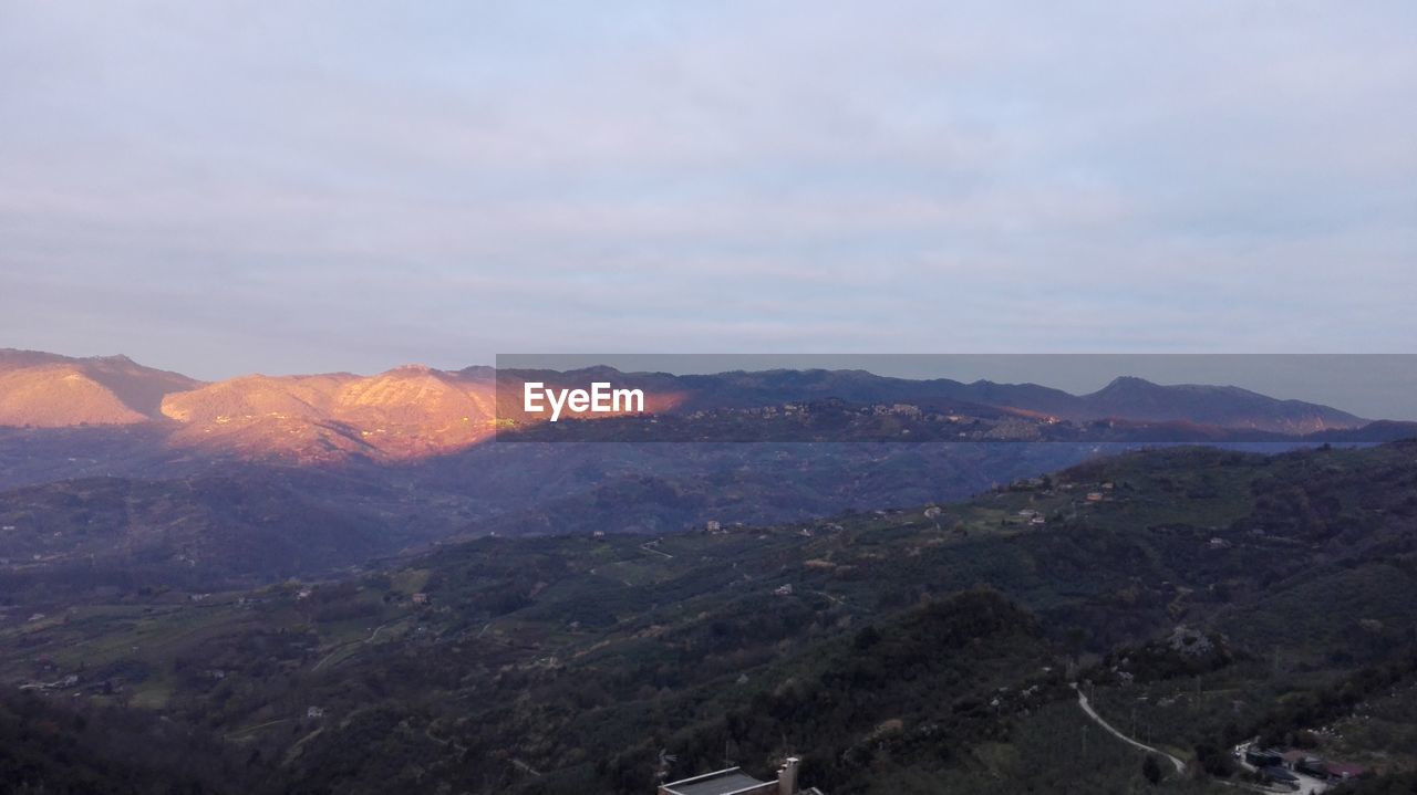 SCENIC VIEW OF MOUNTAINS AGAINST SKY DURING SUNSET