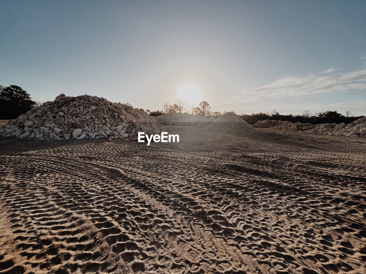 sky, landscape, land, horizon, nature, environment, sand, scenics - nature, natural environment, sunlight, sea, no people, desert, sun, beauty in nature, travel, tranquility, outdoors, cloud, sunny, travel destinations, clear sky, soil, sunset, day, field, non-urban scene, tranquil scene, dry, sunbeam