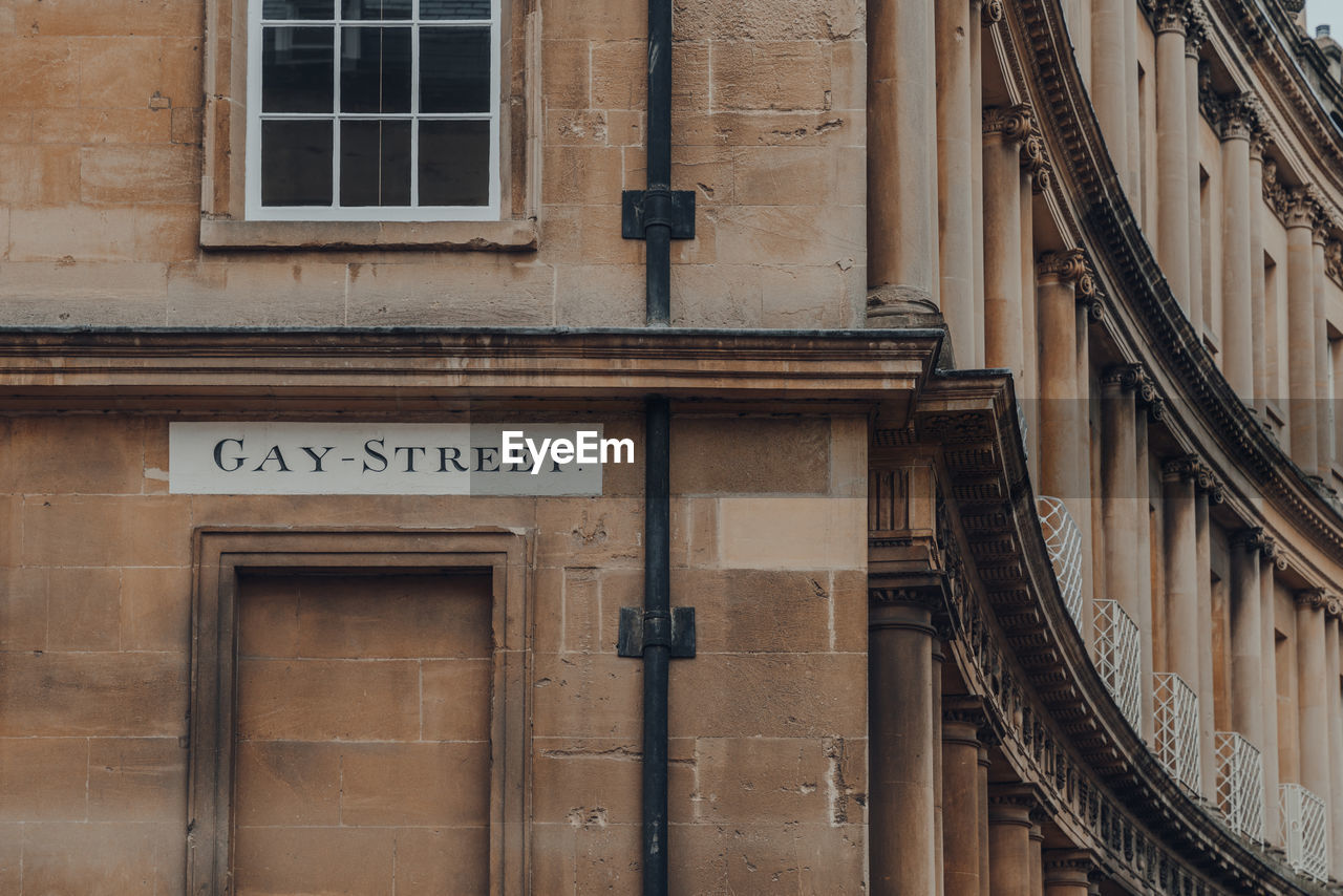 Street name sign on a wall of stone building on gay street in bath, somerset, uk.