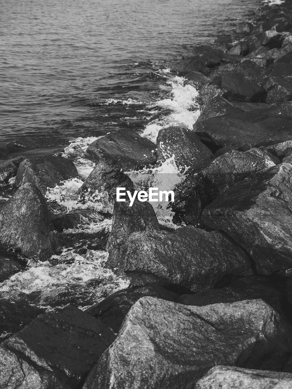 CLOSE-UP OF ROCKS AT BEACH