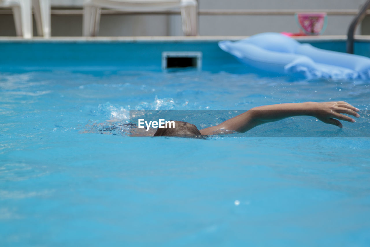 Boy swimming in pool