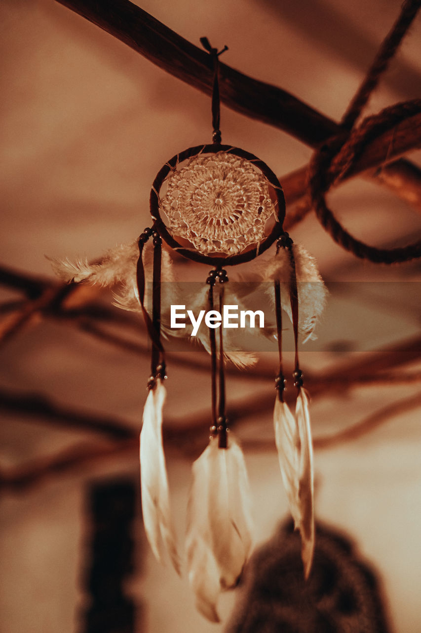 hanging, lighting, light, close-up, no people, macro photography, focus on foreground, indoors, light fixture, black, selective focus, dreamcatcher, iron