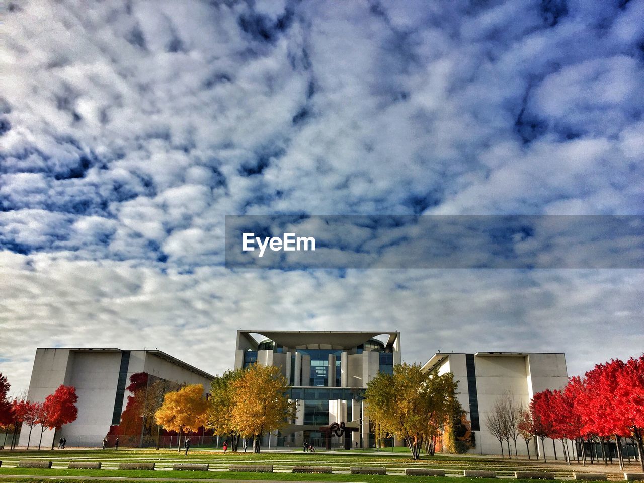 Low angle view of buildings against cloudy sky