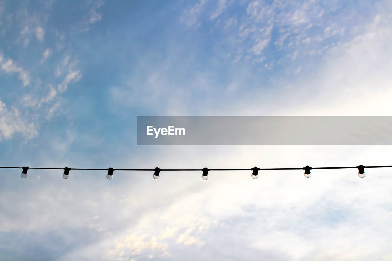 Low angle view of lighting equipment against sky