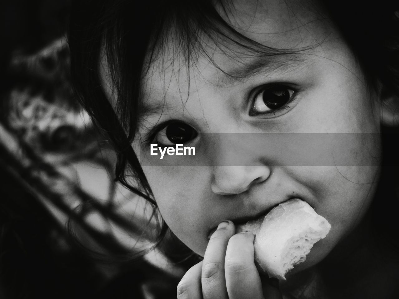 CLOSE-UP PORTRAIT OF CUTE BOY EATING FOOD