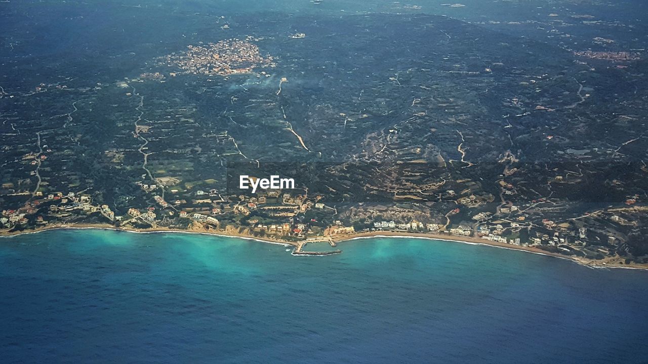 AERIAL VIEW OF SEA AND CITYSCAPE AGAINST SKY