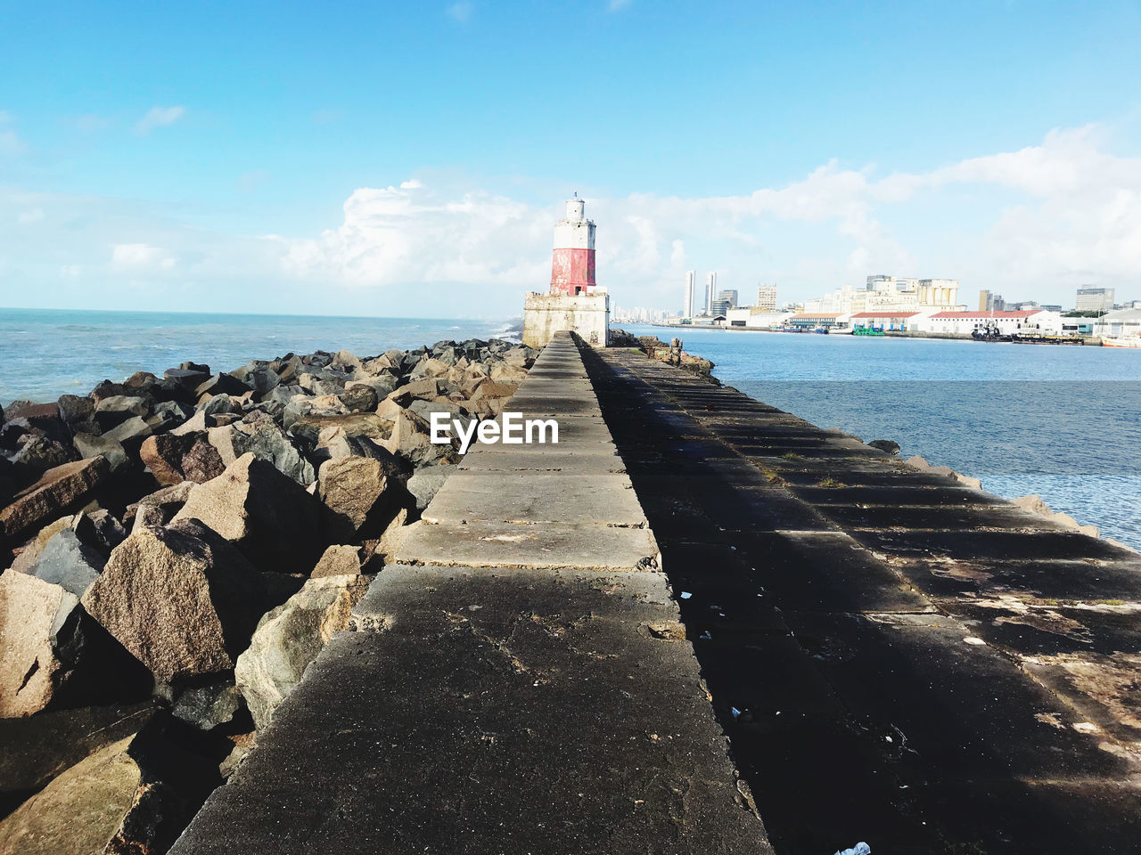 SCENIC VIEW OF SEA BY ROCK AGAINST SKY