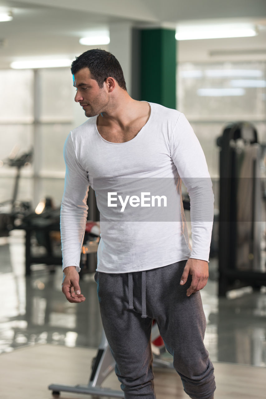 Young man standing at gym