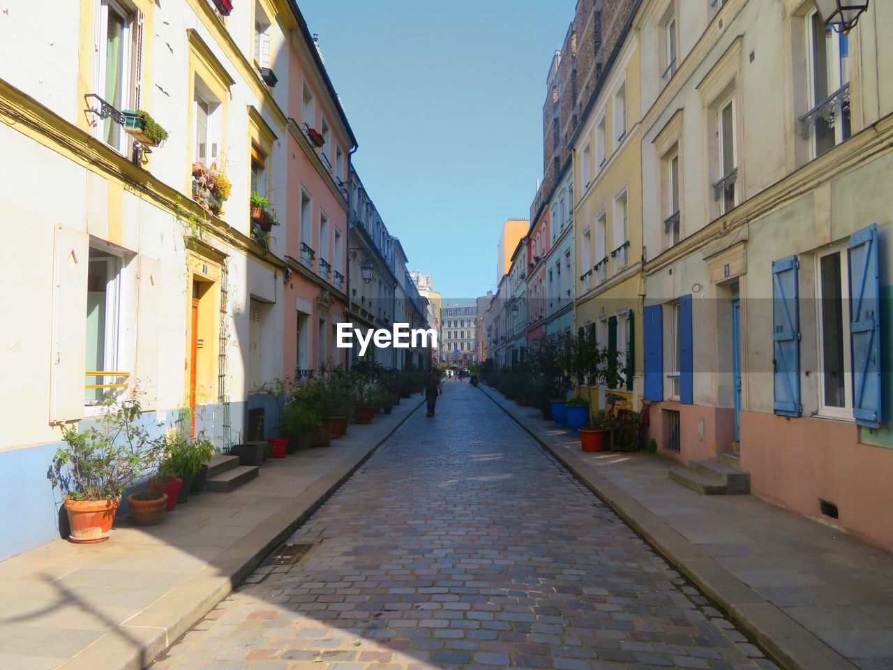 Footpath amidst buildings in city