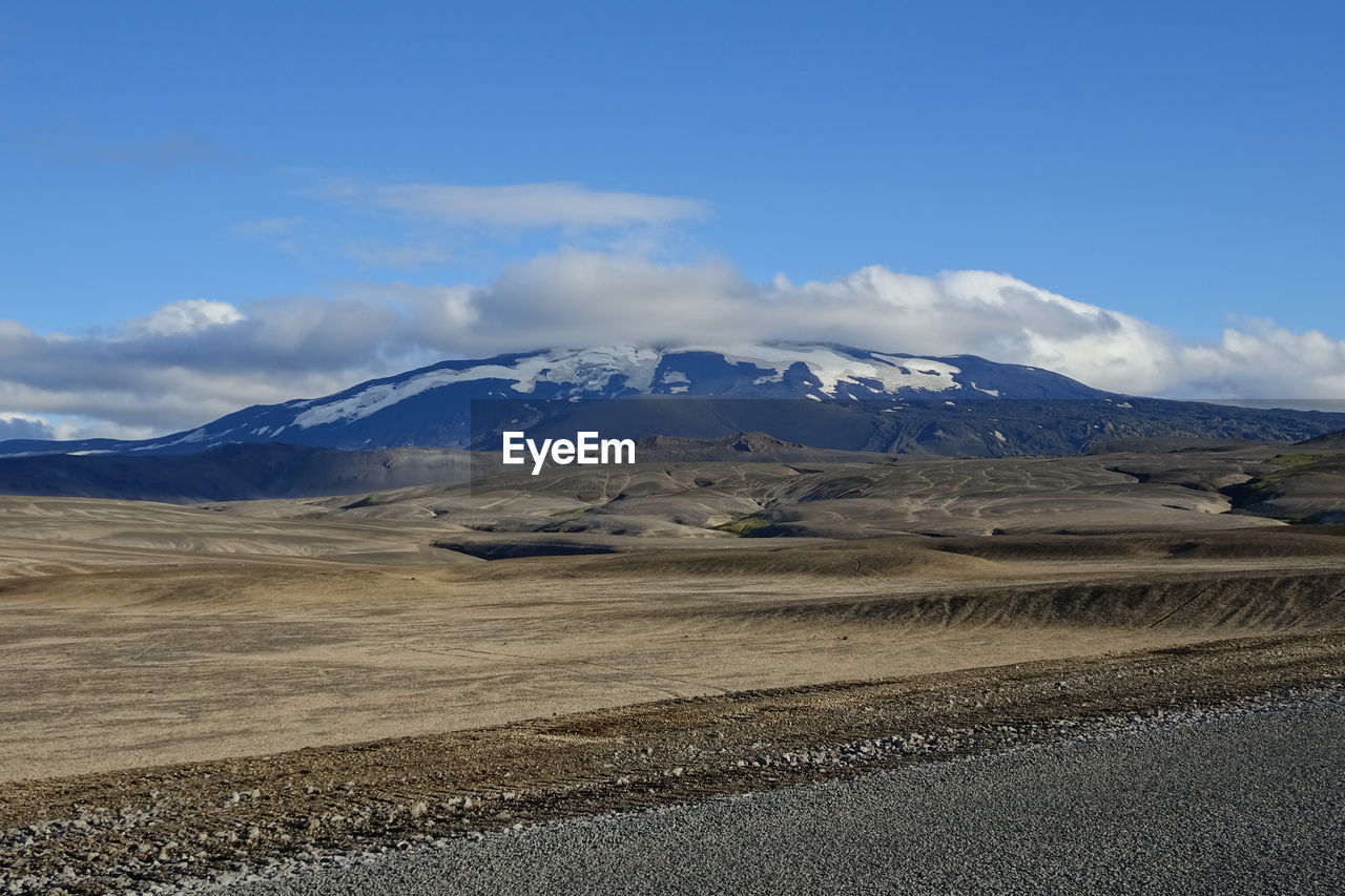 SCENIC VIEW OF SNOWCAPPED MOUNTAINS AGAINST CLOUDY SKY