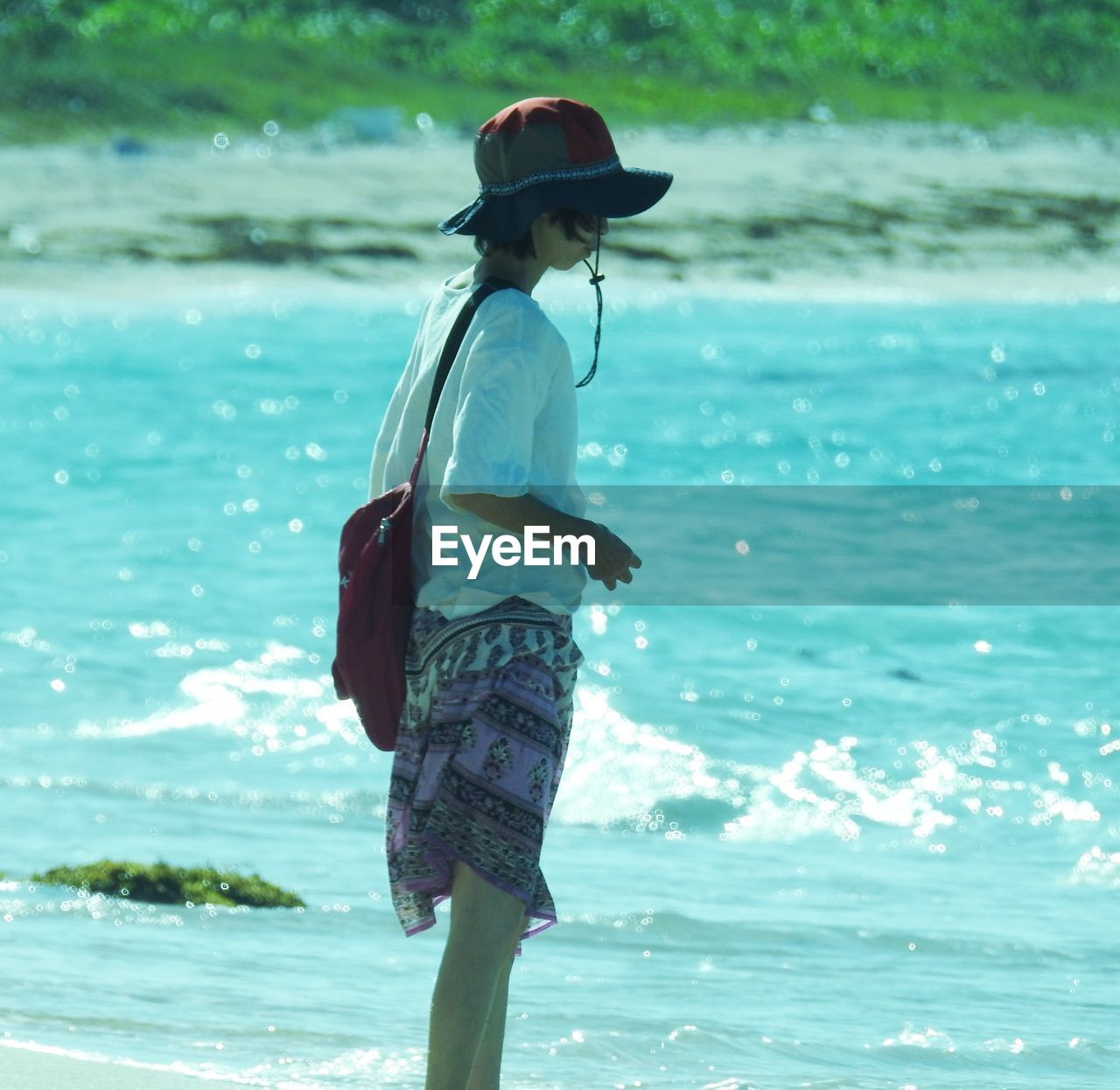 Rear view of man standing on beach