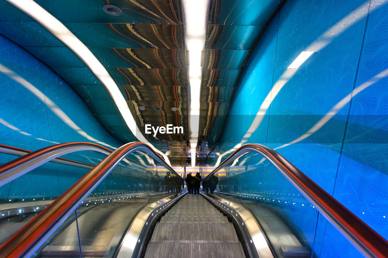 Illuminated escalator at subway station