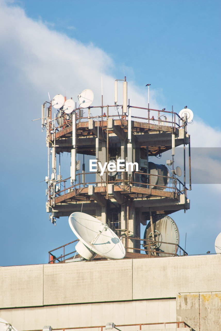 Low angle view of repeater tower against sky