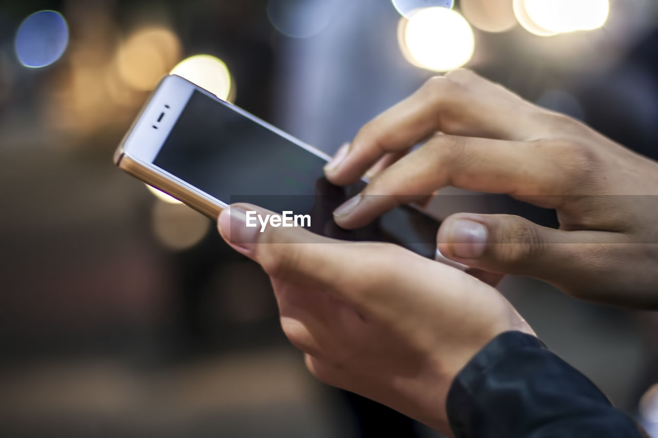 Close-up of man using mobile phone