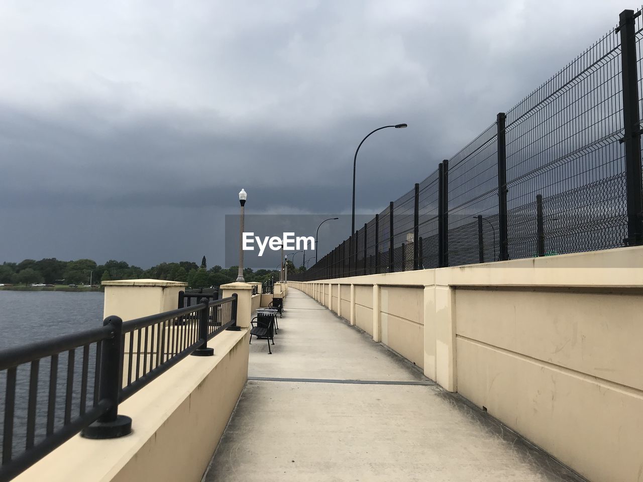 Street lights on bridge against sky