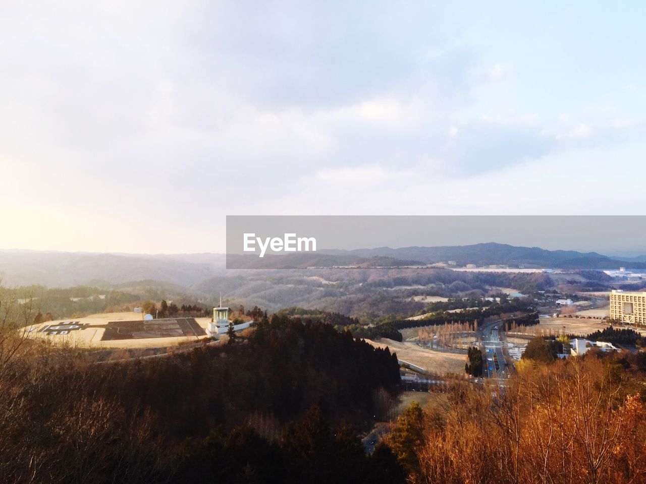 VIEW OF RIVER WITH CITYSCAPE IN BACKGROUND