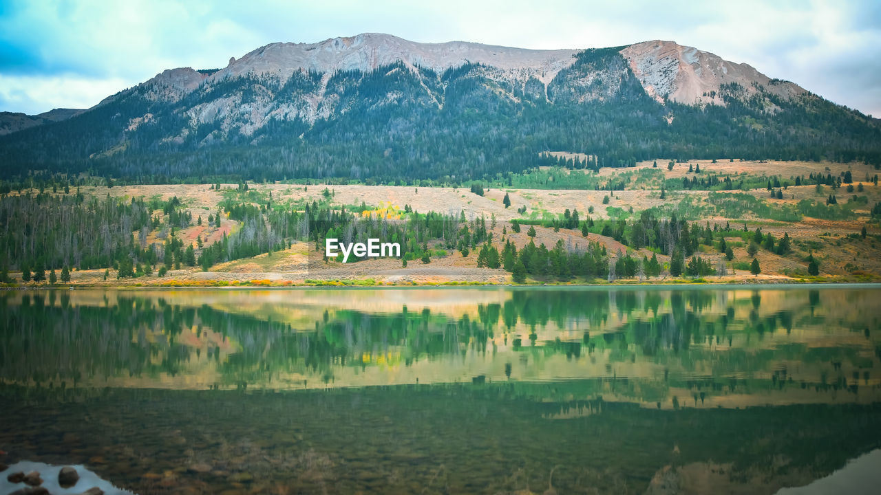 Scenic view of lake and mountains against sky,yellowstone wyoming