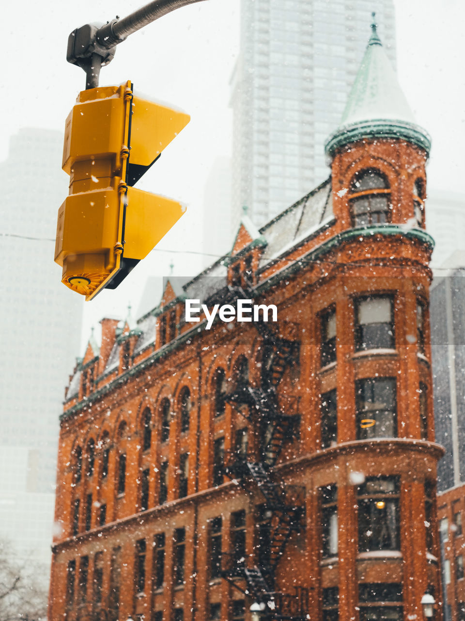 Heavy snowfall in downtown toronto with the gooderham building visible in the background