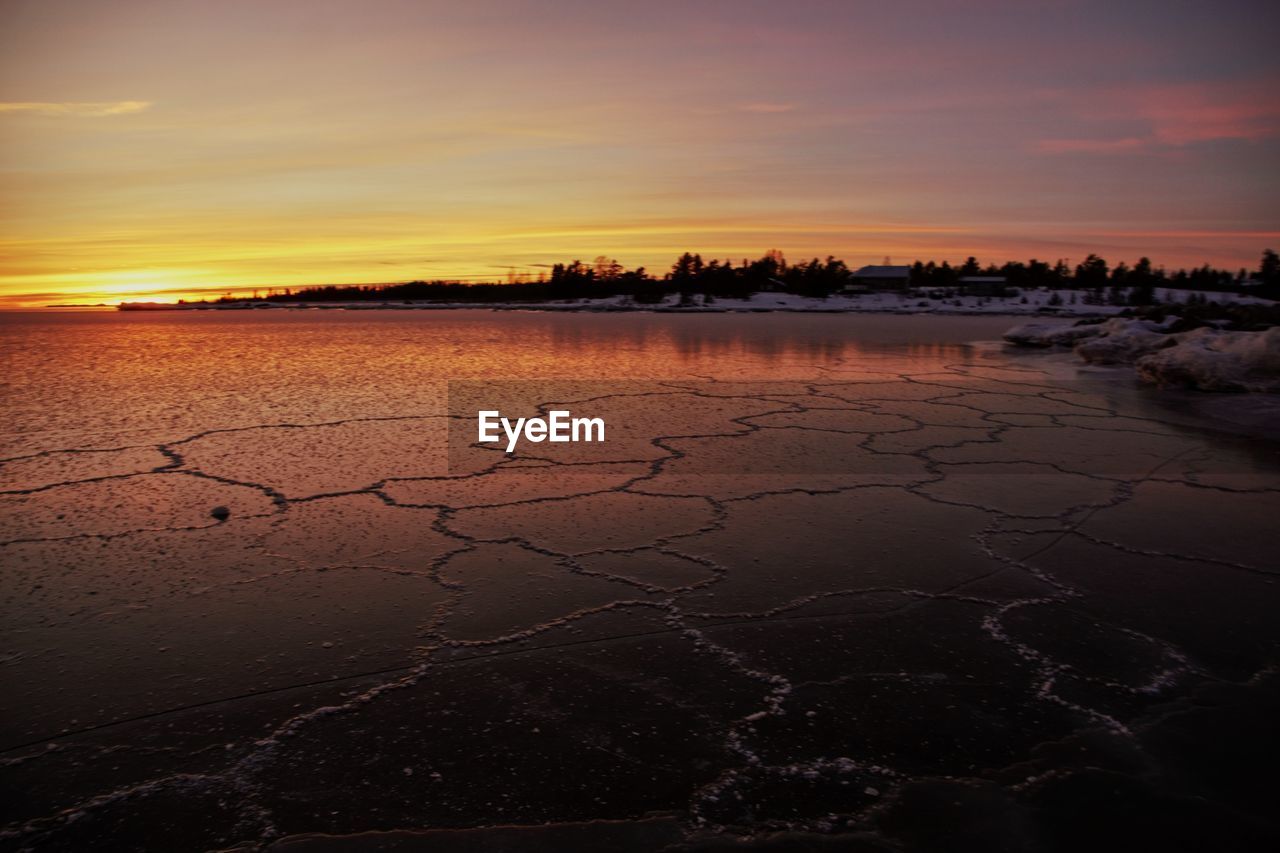 Scenic view of lake against sky during sunset