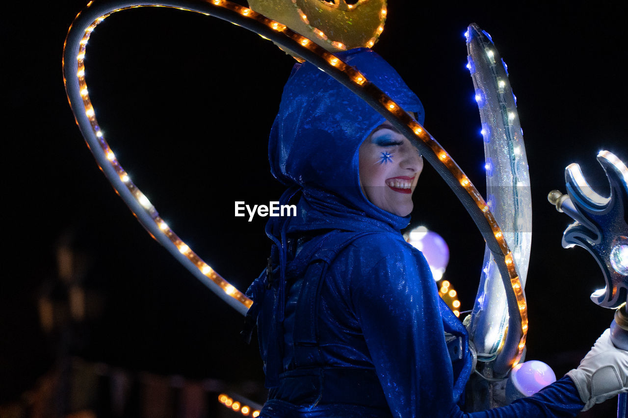 WOMAN HOLDING ILLUMINATED LIGHTING EQUIPMENT