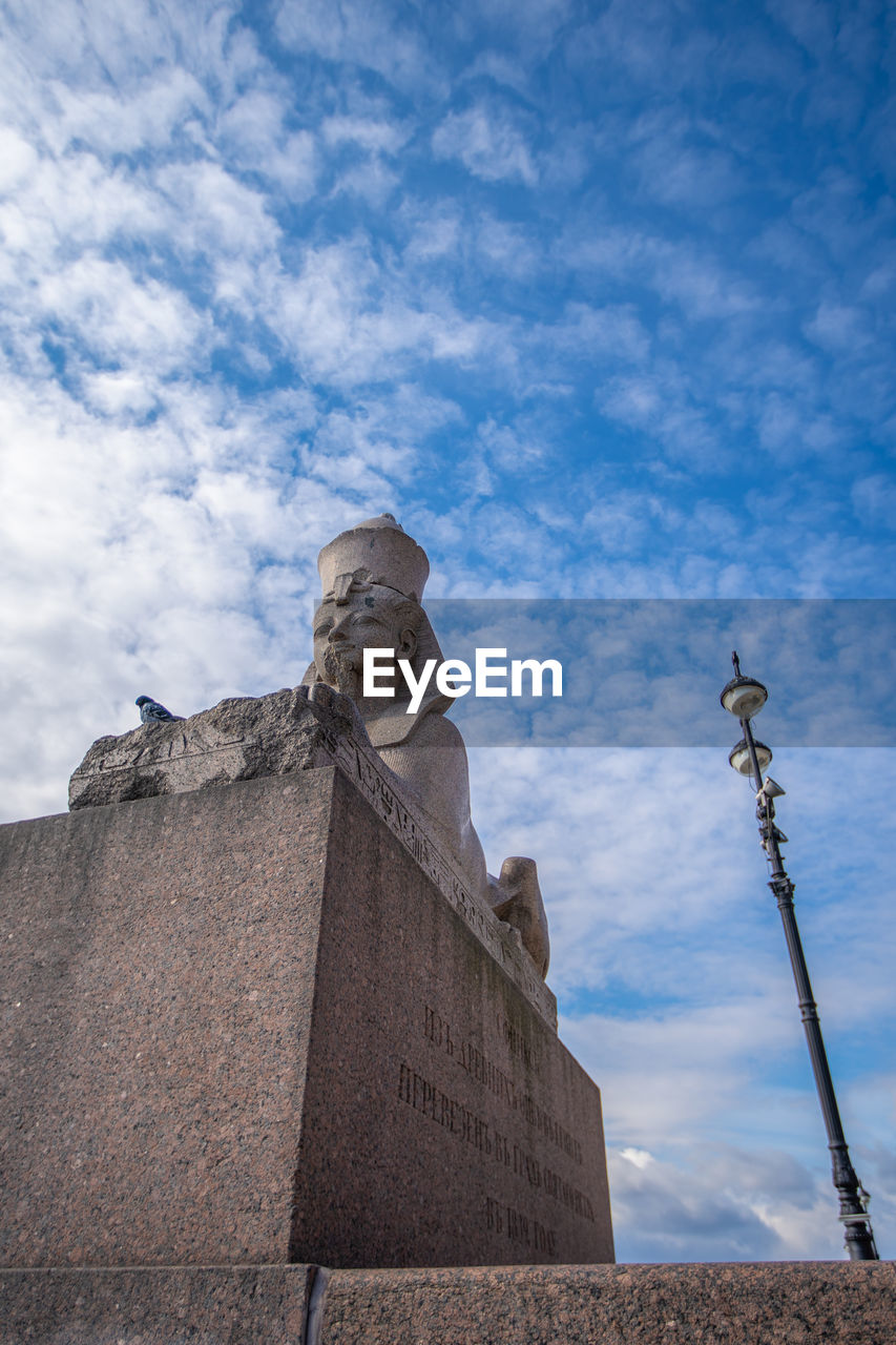 LOW ANGLE VIEW OF STATUE AGAINST CLOUDY SKY