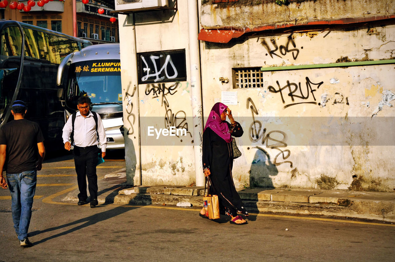 WOMAN IN GRAFFITI WALL