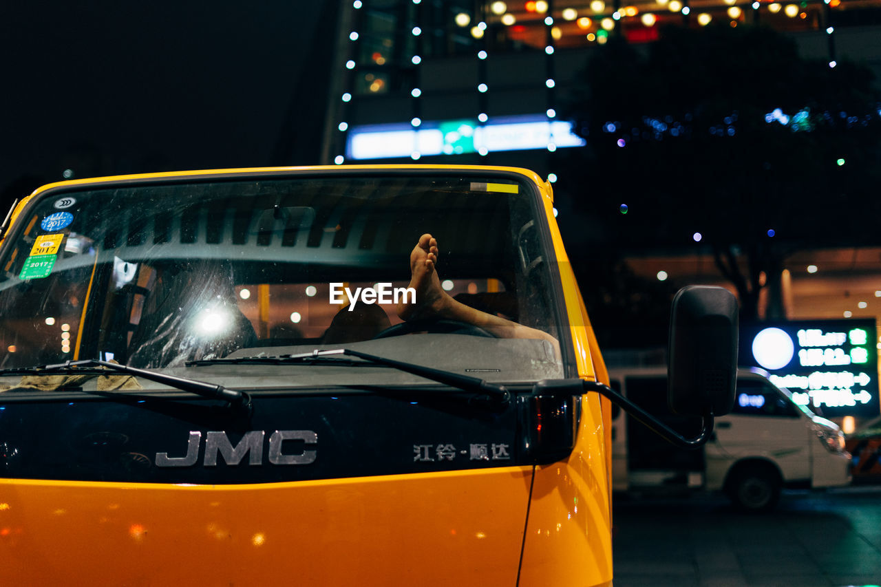 VINTAGE CAR ON ILLUMINATED BUS