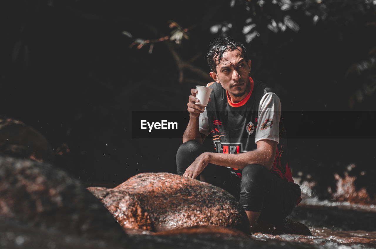 one person, adult, men, sitting, nature, lifestyles, front view, outdoors, person, young adult, leisure activity, land, sports