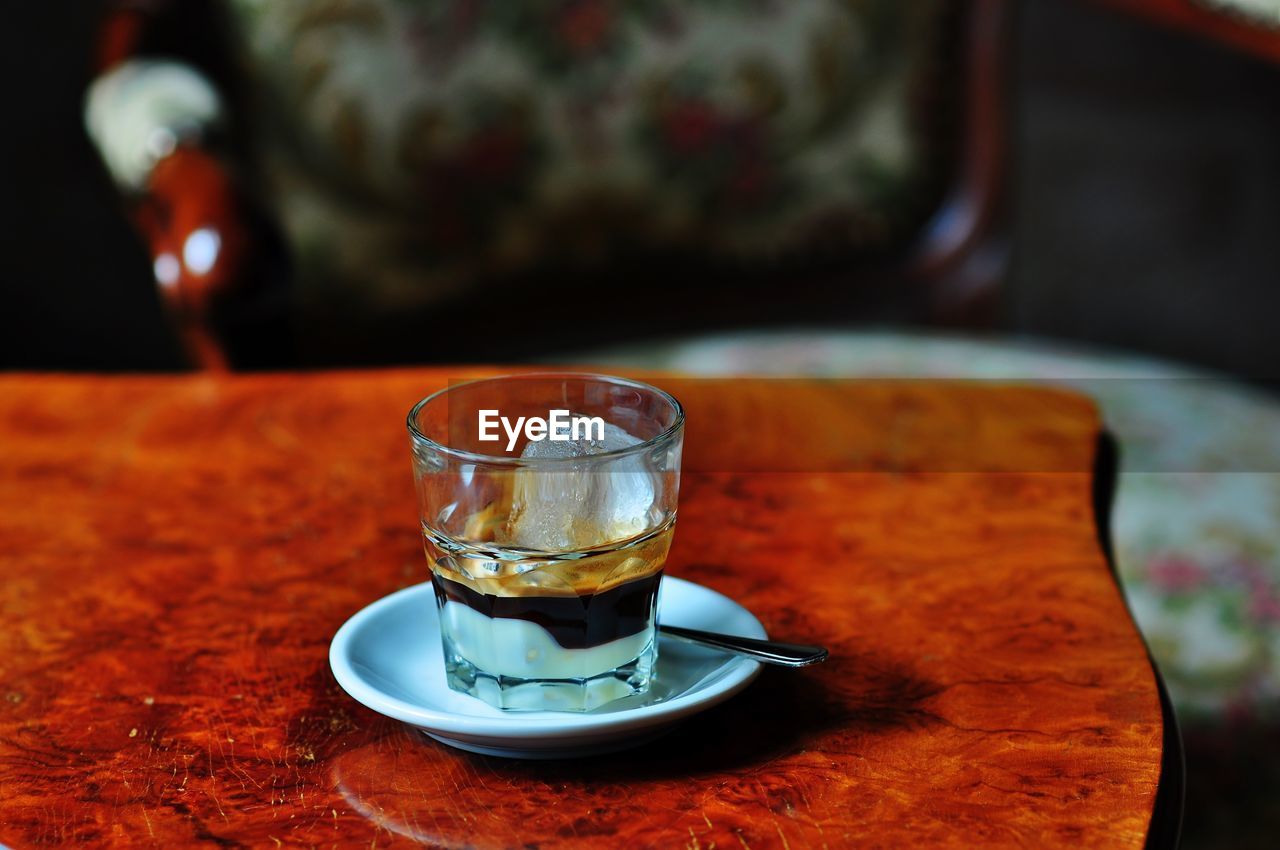 Close-up of espresso with ice in glass on table