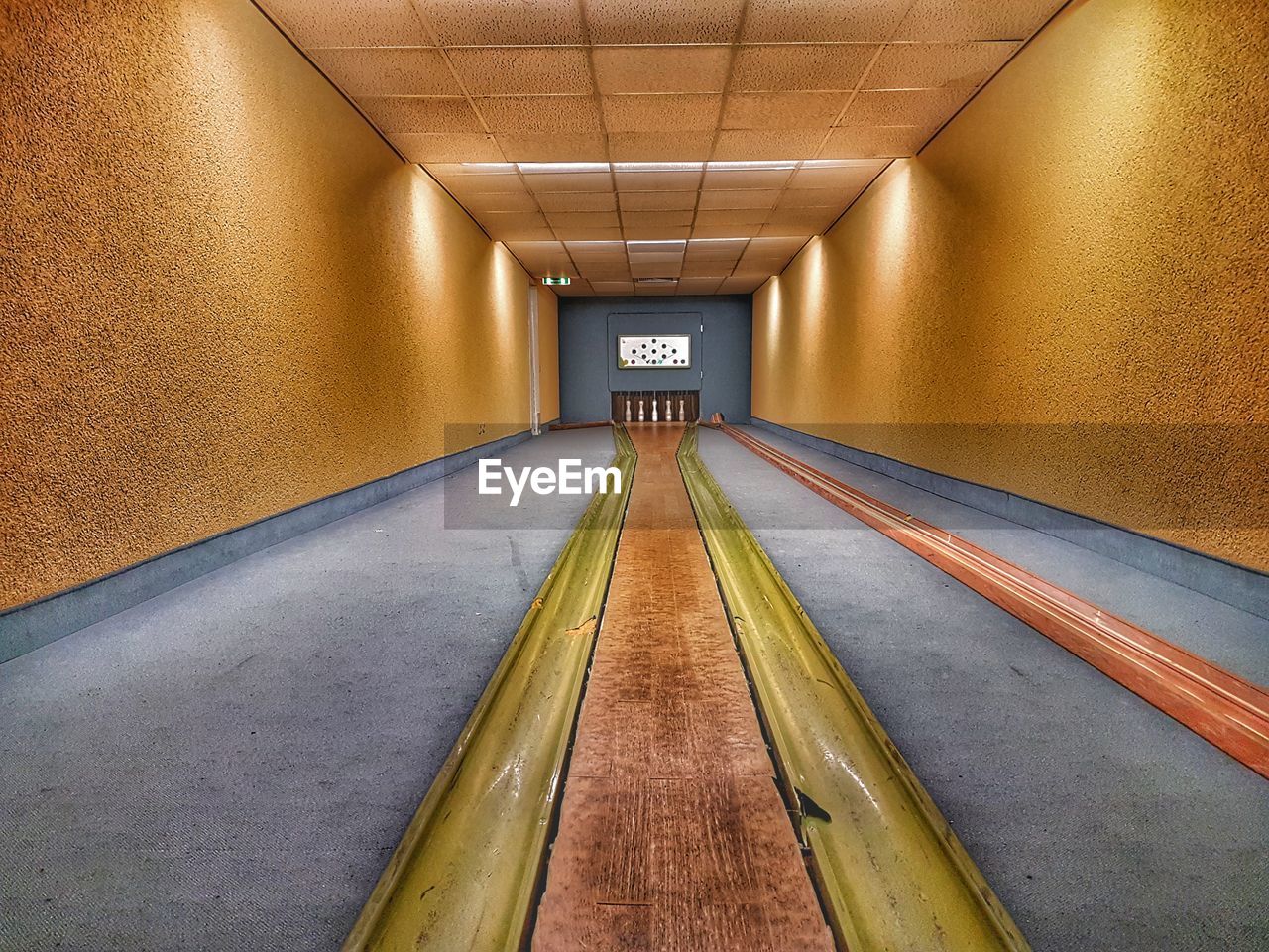 VIEW OF ILLUMINATED EMPTY CORRIDOR