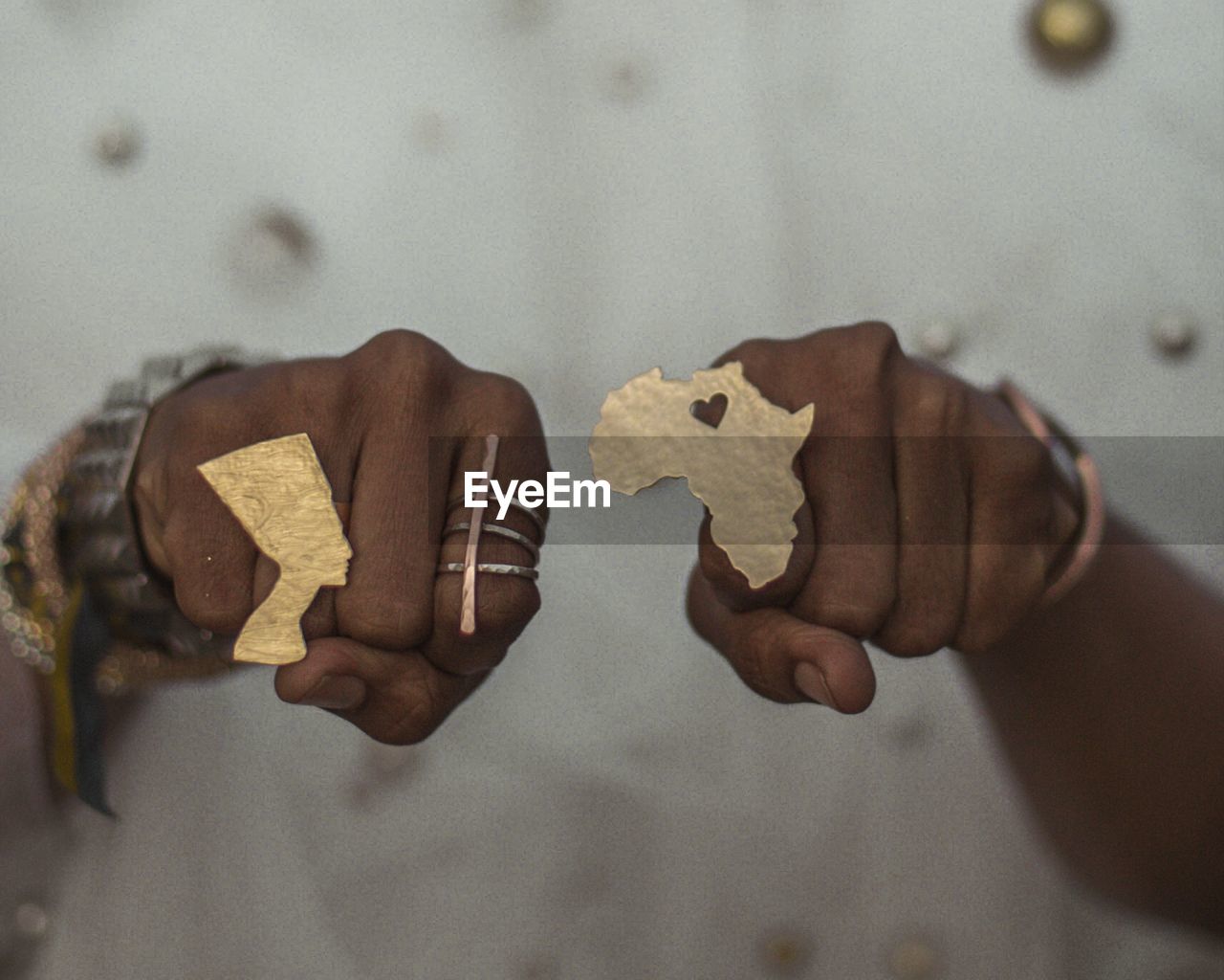 Close-up of hand wearing ring with african map