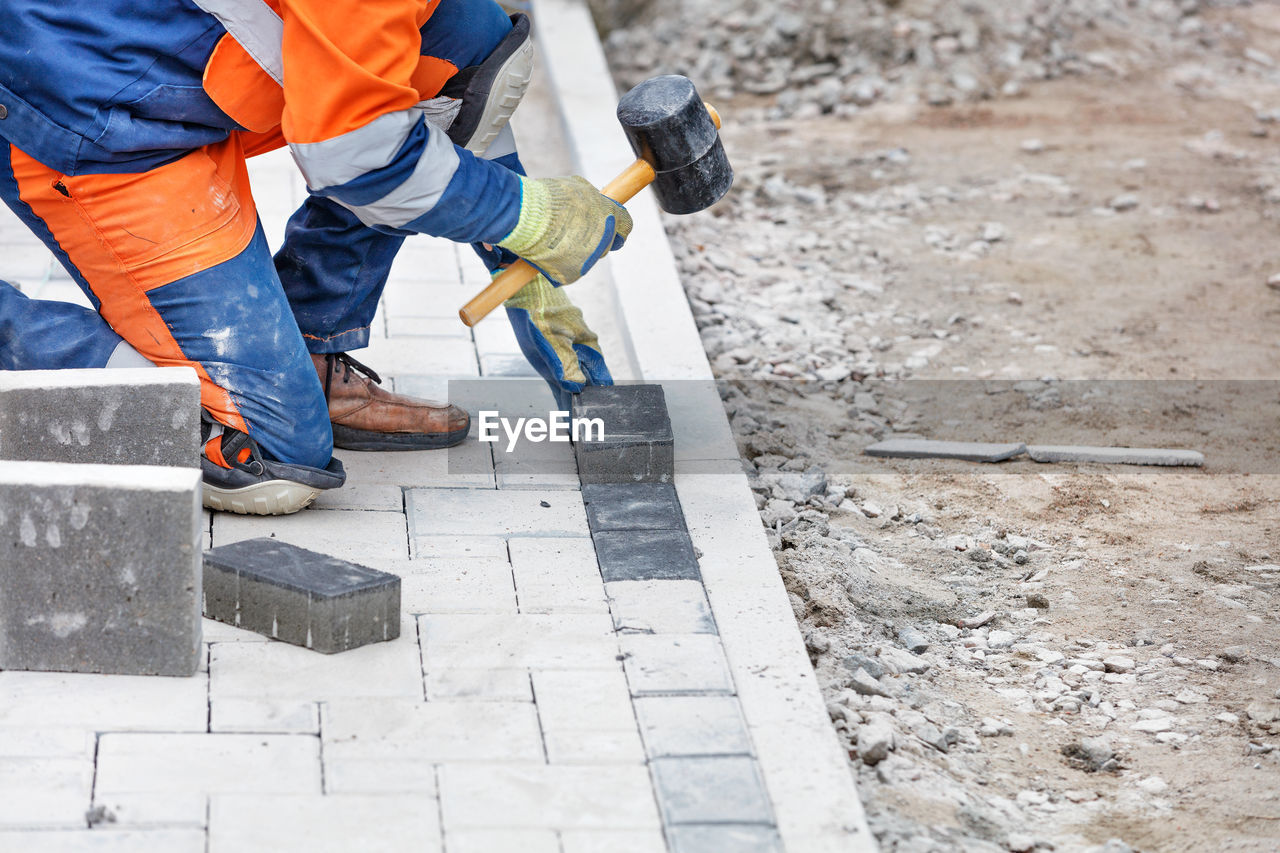 Low section of man working at construction site