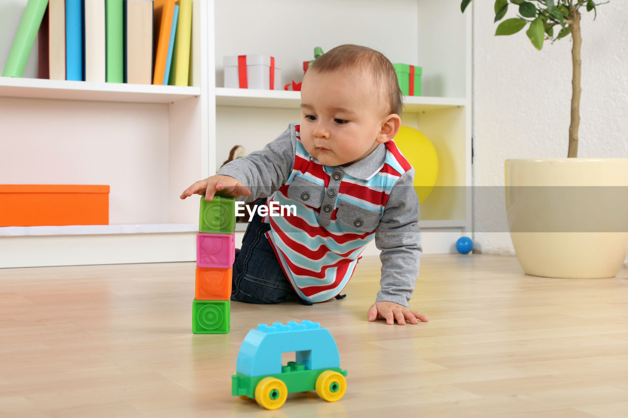 CUTE BABY PLAYING WITH TOY AT HOME
