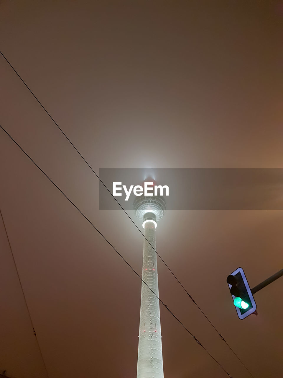 LOW ANGLE VIEW OF ILLUMINATED STREET LIGHTS AGAINST SKY