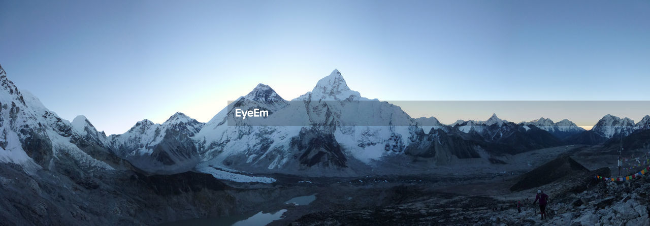 PANORAMIC VIEW OF SNOWCAPPED MOUNTAINS AGAINST CLEAR SKY DURING WINTER