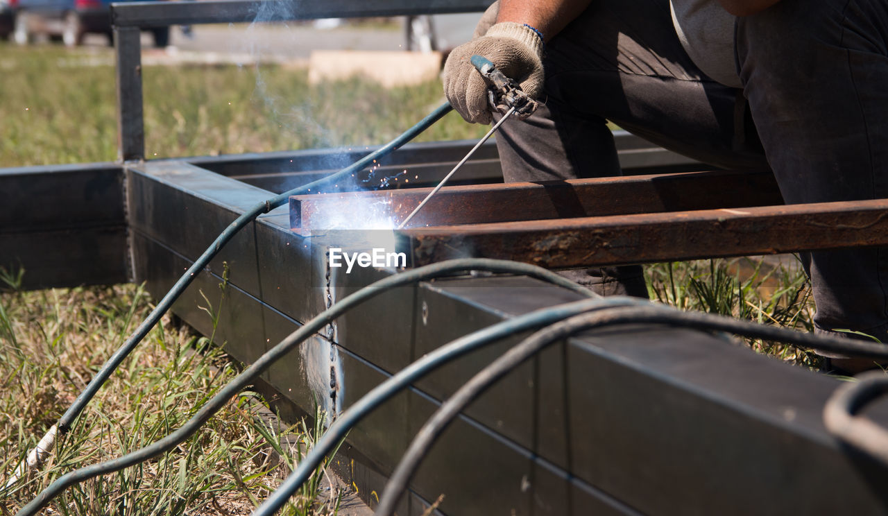 Midsection of welder welding metal