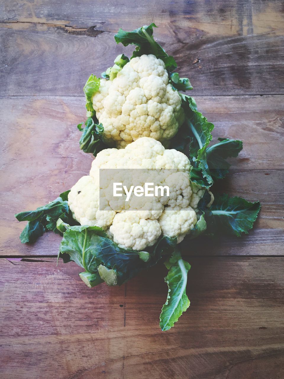 High angle view of cauliflowers on wooden table