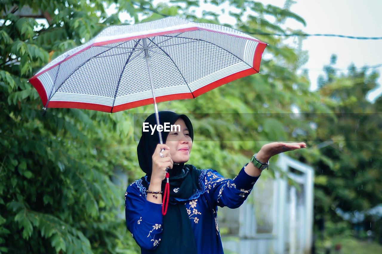 Portrait of woman holding umbrella