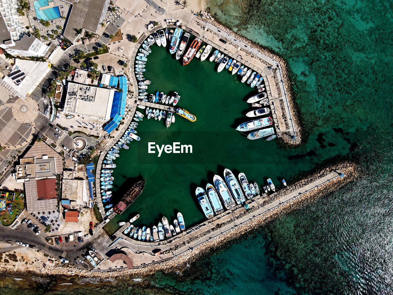 Aerial view of boat moored at sea by town